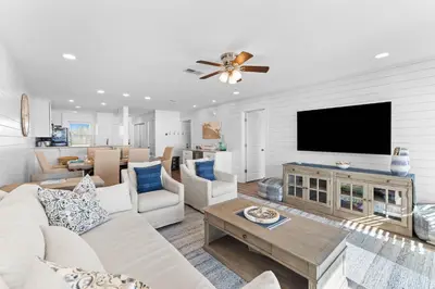 a living room with a couch and a flat screen tv at Ramsgate Harbour #16 by 30A Escapes in Panama City Beach