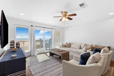 a living room with a couch and a ceiling fan at Ramsgate Harbour #16 by 30A Escapes in Panama City Beach