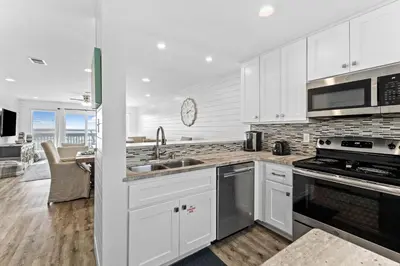 a white kitchen with a sink and a stove at Ramsgate Harbour #16 by 30A Escapes in Panama City Beach