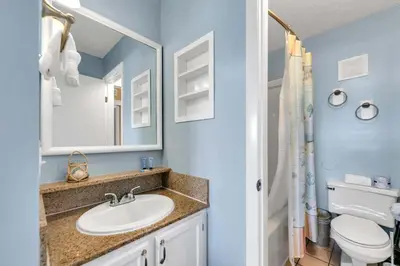 a bathroom with a sink and a toilet at The Summit 1019-Toes in the Sand in Panama City Beach