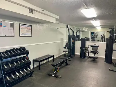 a gym with treadmills and equipment in a room at The Summit 1019-Toes in the Sand in Panama City Beach
