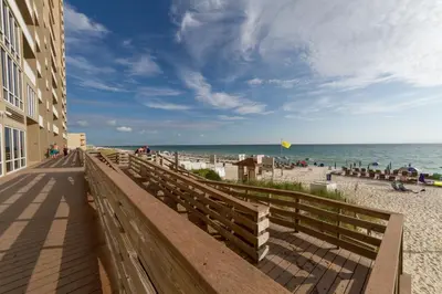 a walkway to the beach near a building at Breathtaking gulf-front condo near Pier Park in Panama City Beach
