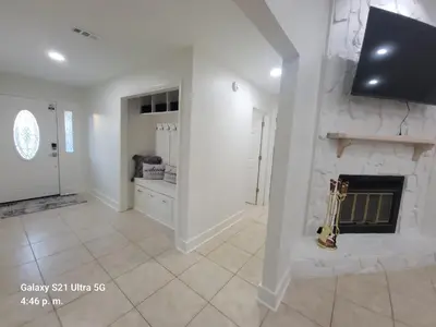 a living room with a fireplace and a guitar at Stunning 4BD Jacuzzi - 4 Min To Beach Panama City in Panama City Beach