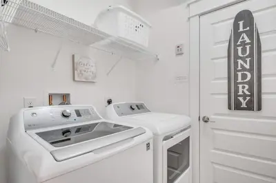 a white laundry room with a washer and dryer at Feeling Tip Sea Golf Cart Bikes Prominence in Watersound Beach