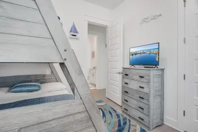 a bedroom with a bed and a tv on a dresser at Feeling Tip Sea Golf Cart Bikes Prominence in Watersound Beach