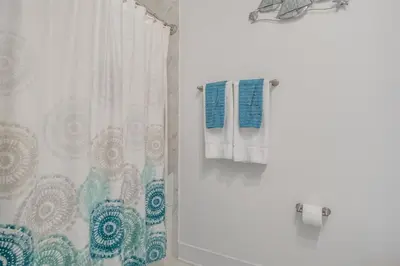 a bathroom with a shower with a shower curtain at Feeling Tip Sea Golf Cart Bikes Prominence in Watersound Beach
