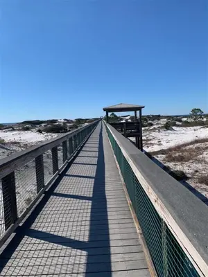 a wooden bridge over the beach with a gazebo at Feeling Tip Sea Golf Cart Bikes Prominence in Watersound Beach