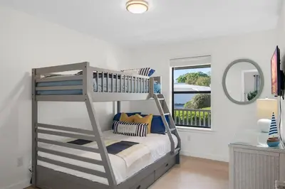 a bedroom with a bunk bed and a mirror at After Dune Delight Pool Tennis Walk To Beach in Seagrove Beach
