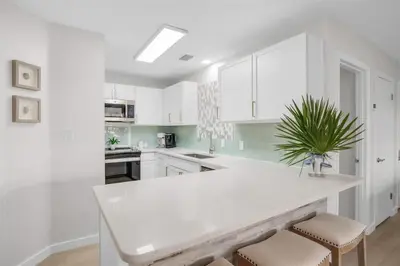 a kitchen with white cabinets and a white counter top at After Dune Delight Pool Tennis Walk To Beach in Seagrove Beach