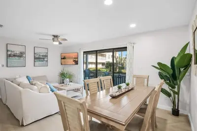 a living room with a table and a couch at After Dune Delight Pool Tennis Walk To Beach in Seagrove Beach