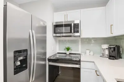 a kitchen with a stainless steel refrigerator and microwave at After Dune Delight Pool Tennis Walk To Beach in Seagrove Beach