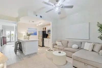 a living room with a couch and a kitchen at Salt Rim Located In Carillon Beach 4 Pools in Carillon Beach
