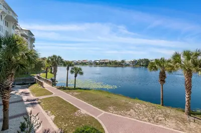 a view of a river with palm trees and a building at Salt Rim Located In Carillon Beach 4 Pools in Carillon Beach