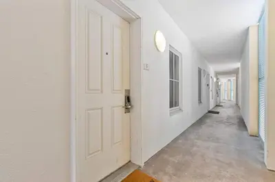 an empty hallway with a white door and white walls at Salt Rim Located In Carillon Beach 4 Pools in Carillon Beach