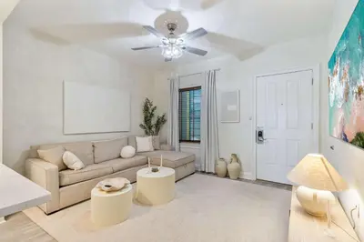 a living room with a couch and a ceiling fan at Salt Rim Located In Carillon Beach 4 Pools in Carillon Beach