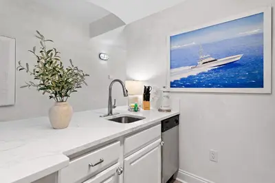 a kitchen with a sink and a boat on the wall at Salt Rim Located In Carillon Beach 4 Pools in Carillon Beach