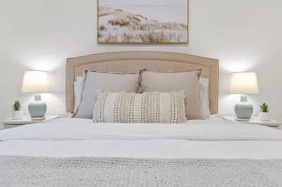a bedroom with a white bed with two lamps at Sea Esta 30A Beautiful Condo Close To Beach in Seagrove Beach