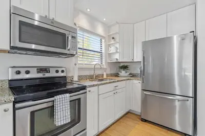 a kitchen with stainless steel appliances and white cabinets at Sea Esta 30A Beautiful Condo Close To Beach in Seagrove Beach
