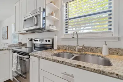 a kitchen with a sink and a microwave at Sea Esta 30A Beautiful Condo Close To Beach in Seagrove Beach