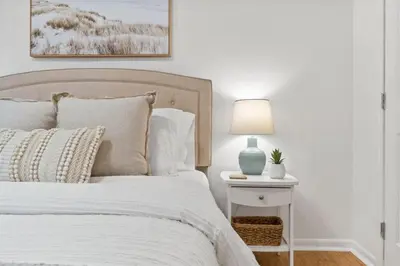 a bedroom with a bed and a lamp on a side table at Sea Esta 30A Beautiful Condo Close To Beach in Seagrove Beach