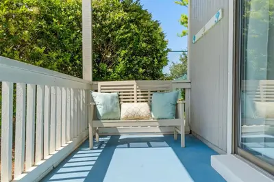 a porch with a bench and a window at Sea Esta 30A Beautiful Condo Close To Beach in Seagrove Beach