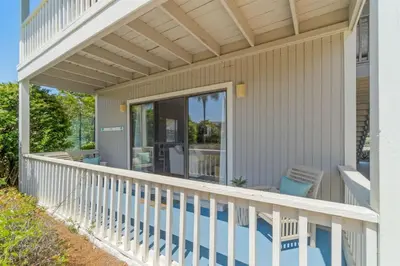 a porch of a house with a white railing at Sea Esta 30A Beautiful Condo Close To Beach in Seagrove Beach