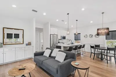 a living room and kitchen with a couch and a table at 30A Caspian Blue Carriage in Seacrest