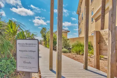 a sign on a walkway in front of a building at 30A Caspian Blue Carriage in Seacrest