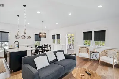 a living room with a couch and a kitchen at 30A Caspian Blue Carriage in Seacrest