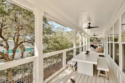 a white porch with a white table and chairs on it at Beach Retreat Gulf View Private Beach in Seacrest