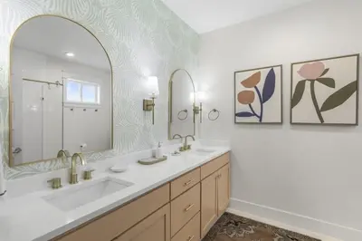 a bathroom with two sinks and a large mirror at Beach Retreat Gulf View Private Beach in Seacrest