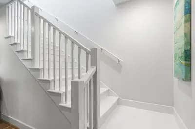 a staircase in a white room with white walls at Beach Retreat Gulf View Private Beach in Seacrest