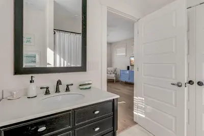 a white bathroom with a sink and a mirror at Beach Retreat Gulf View Private Beach in Seacrest