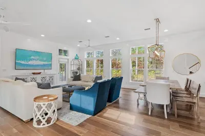 a living room with a couch and a table at 30A Caspian Blue Cottage in Seacrest