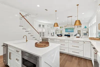 a white kitchen with a sink and a counter at 30A Caspian Blue Cottage in Seacrest