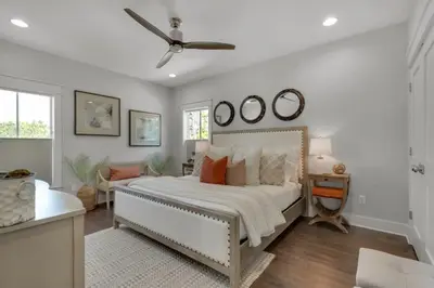 a bedroom with a bed and a ceiling fan at Goin' Coastal Pet Friendly 6-Seater Golf Cart in Seacrest