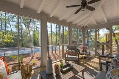 a large screened in porch with a ceiling fan at Goin' Coastal Pet Friendly 6-Seater Golf Cart in Seacrest