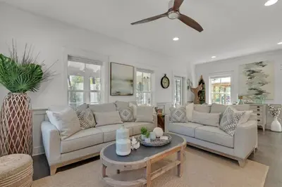 a living room with two couches and a table at Goin' Coastal Pet Friendly 6-Seater Golf Cart in Seacrest
