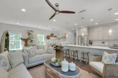 a kitchen and living room with a couch and a table at Goin' Coastal Pet Friendly 6-Seater Golf Cart in Seacrest