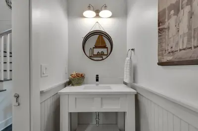 a white bathroom with a sink and a mirror at Goin' Coastal Pet Friendly 6-Seater Golf Cart in Seacrest