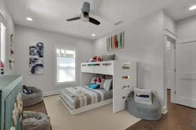 a white bedroom with a bed and two chairs at Goin' Coastal Pet Friendly 6-Seater Golf Cart in Seacrest