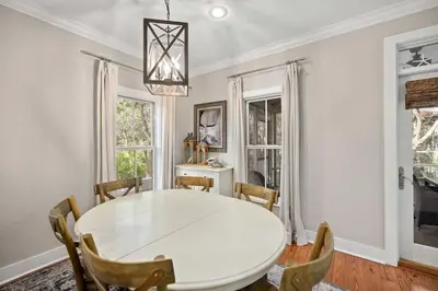 a dining room with a white table and chairs at Driftwood Place Renovations Underway Bikes in Seacrest