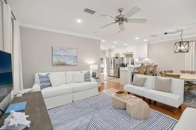 a living room with a white couch and a table at Driftwood Place Renovations Underway Bikes in Seacrest