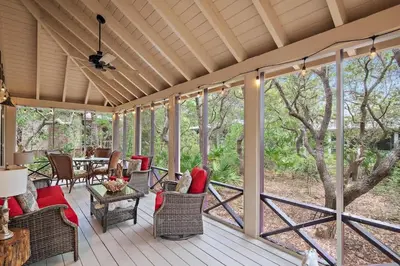 a screened in porch with chairs and a table at Mississippi Magnolia 3 BR 3BA Walk To Beach in Seacrest