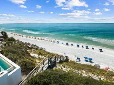 an aerial view of a beach with umbrellas and chairs at Mississippi Magnolia 3 BR 3BA Walk To Beach in Seacrest