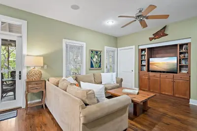 a living room with a couch and a tv at Mississippi Magnolia 3 BR 3BA Walk To Beach in Seacrest
