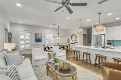 a kitchen and living room with a ceiling fan at Southern Tides 4BR 4 5BA Sleeps 14 Golf Cart in Seacrest