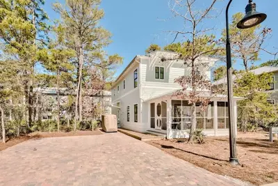 a white house with a street light in front of it at Southern Tides 4BR 4 5BA Sleeps 14 Golf Cart in Seacrest