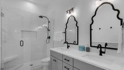 a bathroom with a sink and a toilet and a mirror at Vitamin Sea 4BR 4 5BA Golf Cart Pet Friendly in Seacrest