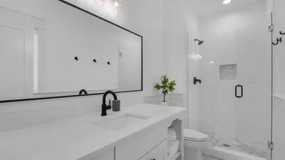 a white bathroom with a sink and a shower at Vitamin Sea 4BR 4 5BA Golf Cart Pet Friendly in Seacrest